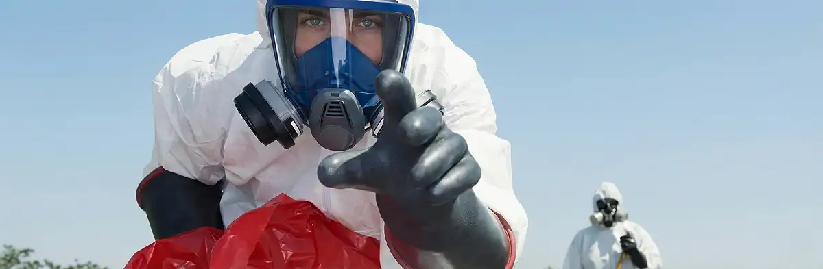 sewage clean up technician wearing protective gear handling biohazard materials in San Antonio, TX