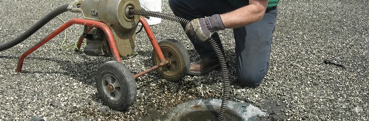sewer rodding technician actively removing blockages from a sewer line in San Antonio, TX