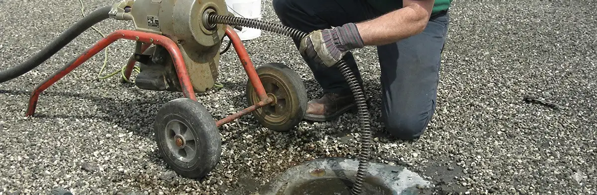 sewer rodding technician actively removing blockages from a sewer line in San Antonio, TX